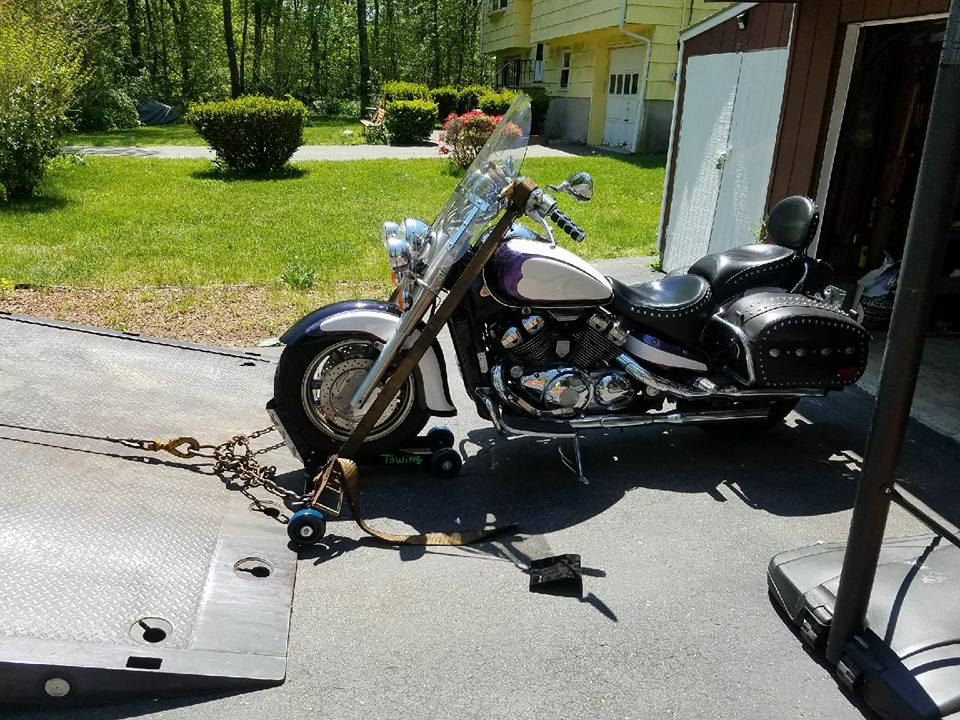 Motorcycle being loaded onto a Flat Bed